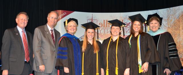 From left, 5-9, middle grades education students Lauren Cox, Peggy Gaona and Jessica Hupp are pinned at the Campbellsville University School of Education Pinning Ceremony. At far left is Dr. Brenda Priddy and Dr. Beverly Ennis, Dr. Michael V. Carter and Dr. Frank Cheatham are at far right. (Campbellsville University Photo by Joan C. McKinney)