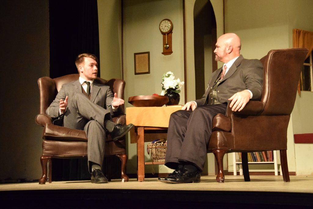 Les Chadwick, as Dr. Stockmann, talks with Tanner Reed of Campbellsville, who plays Hovstad, in “An Enemy of the People.” (Campbellsville University Photo by Shelby Hall)